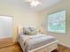 Bedroom featuring wooden floors, ceiling fan, and a bright window to the exterior at 15620 Nw 112Th Ave, Reddick, FL 32686