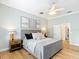 Beautiful bedroom featuring hardwood floors, neutral walls, ceiling fan and decorative artwork at 15620 Nw 112Th Ave, Reddick, FL 32686