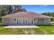 Exterior view of back of house with walk-out patio and three sets of French doors at 15620 Nw 112Th Ave, Reddick, FL 32686