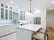 Bright kitchen features white cabinetry, an island with seating, and stainless steel appliances at 15620 Nw 112Th Ave, Reddick, FL 32686