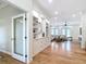 Open-concept living room featuring hardwood floors, built-in shelving, and a glimpse of comfortable seating area at 15620 Nw 112Th Ave, Reddick, FL 32686