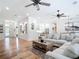 Spacious living room with hardwood floors, large sectional sofa, and open floor plan to kitchen at 15620 Nw 112Th Ave, Reddick, FL 32686