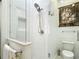 Glass enclosed shower features white subway tile, rainfall shower head, and toilet at 15620 Nw 112Th Ave, Reddick, FL 32686