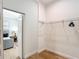 Walk-in closet features hardwood floors, wire shelving and door into bedroom at 15620 Nw 112Th Ave, Reddick, FL 32686
