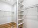 Spacious walk-in closet features mirror, white shelving, and hardwood floors at 15620 Nw 112Th Ave, Reddick, FL 32686