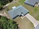 Aerial shot of the home showcasing its layout, landscaping, long driveway and garden beds at 15994 Sw 55Th Avenue Rd, Ocala, FL 34473