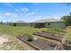 Lovely backyard view showcasing garden beds, a well-kept lawn, and partial view of the house at 15994 Sw 55Th Avenue Rd, Ocala, FL 34473