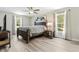 Bedroom with a wooden bed frame, neutral walls, and natural light from two windows at 15994 Sw 55Th Avenue Rd, Ocala, FL 34473