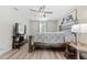 Bedroom showcasing hardwood floors, a queen bed, and a view of the television set at 15994 Sw 55Th Avenue Rd, Ocala, FL 34473