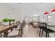 Open-concept dining area with table, chairs, and modern lighting at 15994 Sw 55Th Avenue Rd, Ocala, FL 34473
