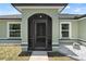 Charming entryway with a screened-in porch, stylish door, and house number display at 15994 Sw 55Th Avenue Rd, Ocala, FL 34473