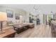 Open-concept living room and kitchen area with hardwood floors and modern lighting fixtures at 15994 Sw 55Th Avenue Rd, Ocala, FL 34473
