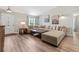 Spacious living room featuring a large sectional sofa, wood floors, and modern decor at 15994 Sw 55Th Avenue Rd, Ocala, FL 34473