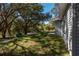 Expansive backyard with mature trees and lush green grass at 16615 Se 63Rd Ln, Ocklawaha, FL 32179