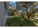 View of the spacious backyard featuring a lush lawn and mature trees, offering privacy and serenity at 16615 Se 63Rd Ln, Ocklawaha, FL 32179