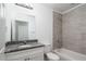 Bathroom featuring a shower-tub combo with tiled walls and granite countertops at 16615 Se 63Rd Ln, Ocklawaha, FL 32179