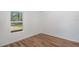 Bright bedroom featuring wood-look floors and a window offering natural light at 16615 Se 63Rd Ln, Ocklawaha, FL 32179