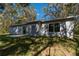 Rear exterior view of the home showing siding and sliding glass door at 16615 Se 63Rd Ln, Ocklawaha, FL 32179