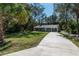 Inviting home featuring a long driveway and well-maintained lawn at 16615 Se 63Rd Ln, Ocklawaha, FL 32179