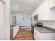 Open-concept kitchen with granite countertops, stainless appliances, and wood-look flooring at 16615 Se 63Rd Ln, Ocklawaha, FL 32179
