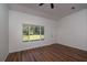 Bright living room with hardwood floors, ceiling fan, and view to the backyard at 16615 Se 63Rd Ln, Ocklawaha, FL 32179