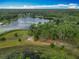 Picturesque lakefront property with lush greenery and mature trees at 16621 Se 57Th Pl, Ocklawaha, FL 32179