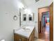 A practical bathroom featuring a vanity with a sink, a mirror, and a glimpse into an adjacent room at 16621 Se 57Th Pl, Ocklawaha, FL 32179