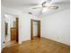 Bedroom with hardwood floors, closet, and ceiling fan at 16621 Se 57Th Pl, Ocklawaha, FL 32179