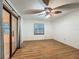 Bedroom featuring wood floors, a ceiling fan, sliding glass door and a window at 16621 Se 57Th Pl, Ocklawaha, FL 32179