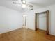 Bedroom with hardwood floors, closet, and ceiling fan at 16621 Se 57Th Pl, Ocklawaha, FL 32179