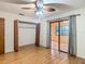 Bedroom with hardwood floors, closet, ceiling fan, and sliding glass doors at 16621 Se 57Th Pl, Ocklawaha, FL 32179
