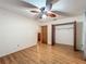 Bedroom with hardwood floors, closet, and ceiling fan at 16621 Se 57Th Pl, Ocklawaha, FL 32179