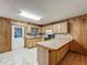 Functional kitchen featuring wooden cabinets, a breakfast bar, and tiled flooring, perfect for casual dining and meal preparation at 16621 Se 57Th Pl, Ocklawaha, FL 32179