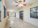 Bright, open living space with tiled floors, multiple windows, and sliding glass doors enhancing natural light and ventilation at 16621 Se 57Th Pl, Ocklawaha, FL 32179
