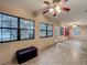 Open living area filled with natural light, featuring tiled flooring and large windows overlooking the serene outdoor landscape at 16621 Se 57Th Pl, Ocklawaha, FL 32179