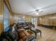 Inviting living room with wood paneling, laminate floors, and a large sectional sofa, creating a comfortable gathering space at 16621 Se 57Th Pl, Ocklawaha, FL 32179