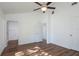 Spacious bedroom with a ceiling fan, wood floors and access to en-suite bathroom at 17009 Se 60Th St, Ocklawaha, FL 32179
