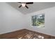 Bright bedroom featuring a ceiling fan and large window providing natural light at 17009 Se 60Th St, Ocklawaha, FL 32179