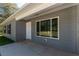 Covered front porch featuring a window, white door, and gray siding at 17009 Se 60Th St, Ocklawaha, FL 32179