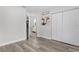 Bright bedroom boasts wood flooring and an ensuite bathroom down the hall at 18 Banyan Pass, Ocala, FL 34472
