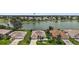 Aerial view of homes overlooking a scenic lake, offering serene waterfront living and beautiful community surroundings at 2002 Enrique Dr, Lady Lake, FL 32159