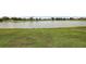 Lakeside backyard with green grass at 2002 Enrique Dr, Lady Lake, FL 32159