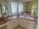Bathroom with double sinks and vanity with tiled floors and shower at 2002 Enrique Dr, Lady Lake, FL 32159