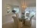 Elegant dining room with crystal chandelier, mirror accent wall and seating for four at 2002 Enrique Dr, Lady Lake, FL 32159