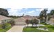 Charming home with a well-maintained lawn, beautiful landscaping, and an attached two-car garage at 2002 Enrique Dr, Lady Lake, FL 32159