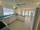 Bright kitchen features tile flooring, white cabinets and appliances, and an eat-in breakfast nook at 2002 Enrique Dr, Lady Lake, FL 32159