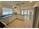 Bright kitchen features tile flooring, white cabinets and appliances, and an eat-in breakfast nook at 2002 Enrique Dr, Lady Lake, FL 32159