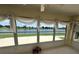 Bright sunroom offering stunning views of the lake and surrounding landscape at 2002 Enrique Dr, Lady Lake, FL 32159