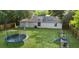 Large backyard featuring lots of space, a trampoline, playset and well-manicured lawn at 2263 Moines Ct, Dunnellon, FL 34431