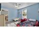 Bright bedroom with closet, featuring a ceiling fan and plenty of natural light from the large window at 2263 Moines Ct, Dunnellon, FL 34431
